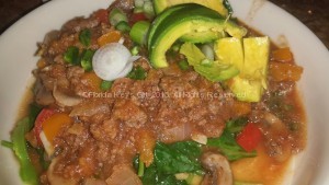 Chili, made with butternut squash, over spinach.